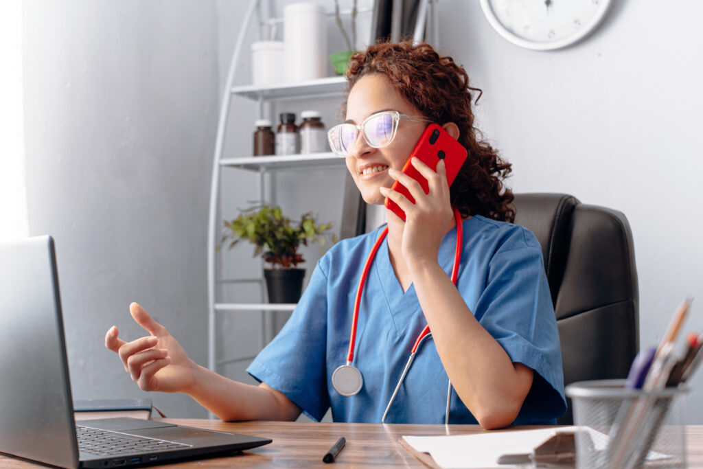 Doctor making a call with a mobile phone.