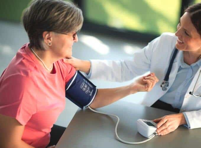 blog-article-image Senior woman receives a blood pressure check from a friendly doctor in a bright doctor office