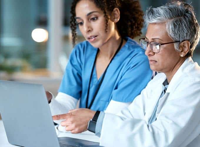 blog-article-image Doctor, team with healthcare and women with laptop, working together and digital hospital schedule or agenda. Technology, medical innovation and collaboration, partnership and cardiovascular surgeon